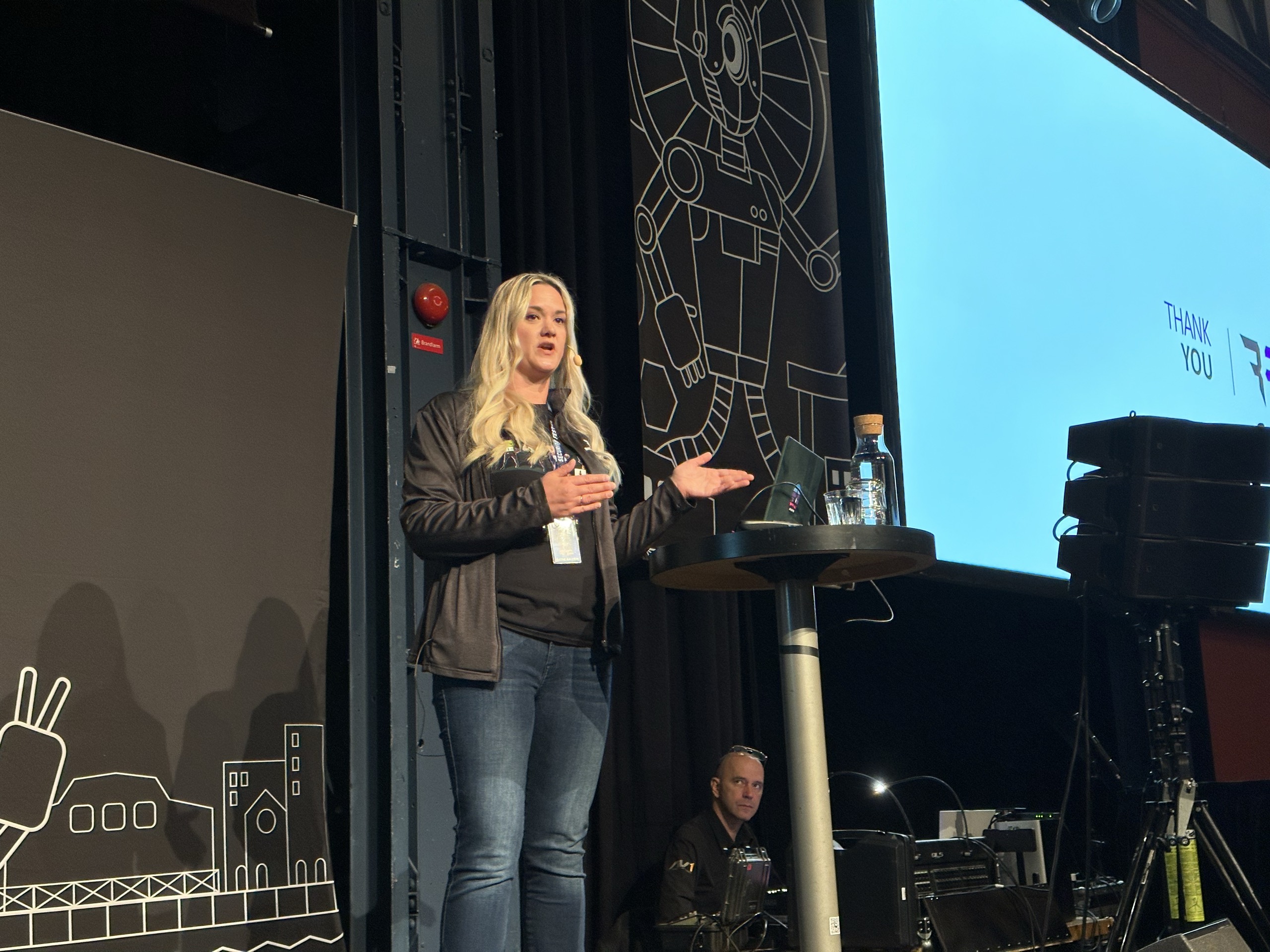 Alethe gesturing during her SecurityFest presentation